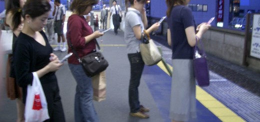 people using smartphones in public